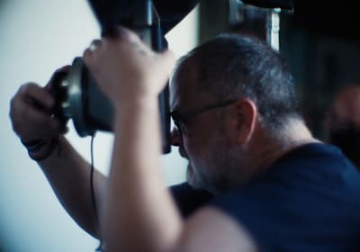 a man holding a camera up to take a picture