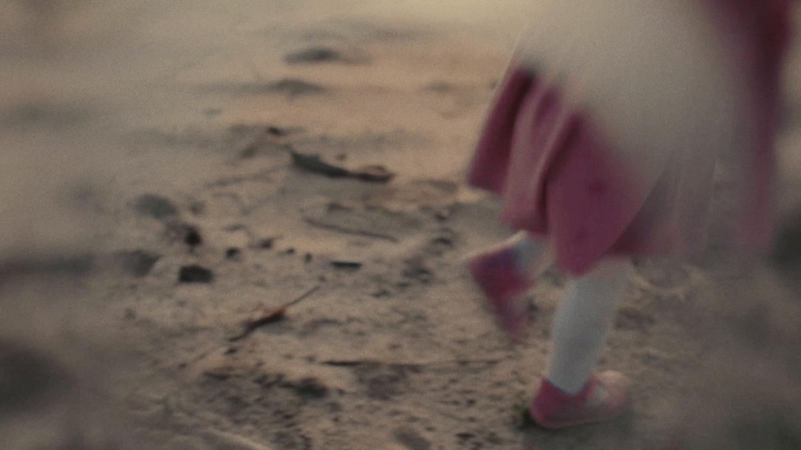 a blurry photo of a person walking on a beach