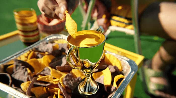 a tray of chips and a goblet of wine