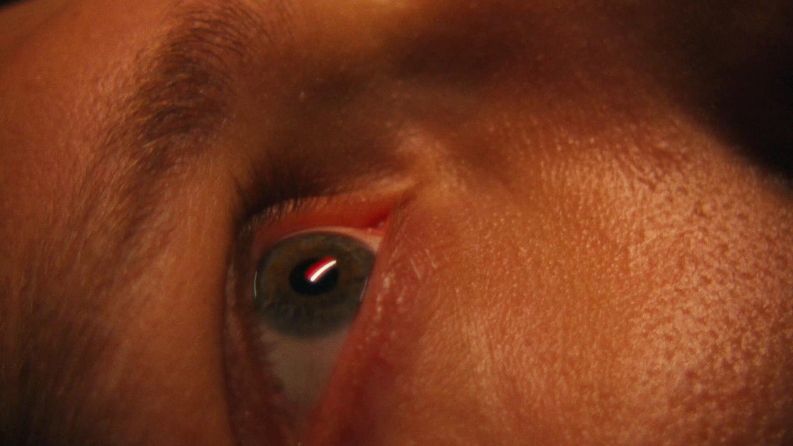 a close up of a person's eye with a red spot on the iris