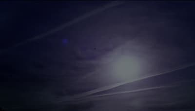 the sun is shining brightly in the dark sky