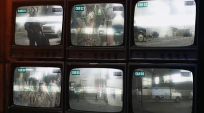 a bunch of tvs that are sitting on a wall