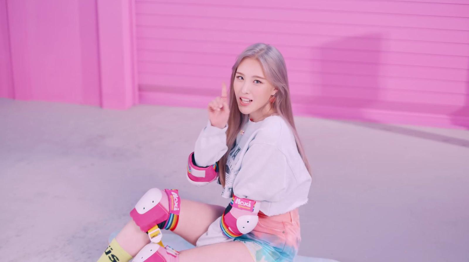 a girl sitting on the ground with her legs crossed