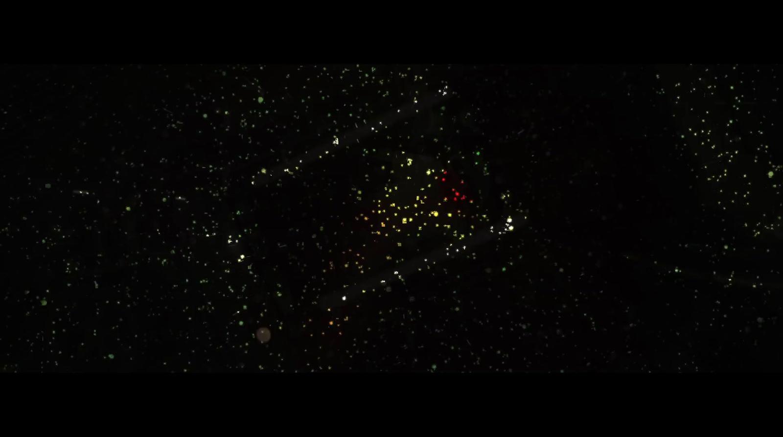 a black sky filled with lots of green and yellow fireworks