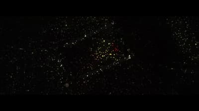 a black sky filled with lots of green and yellow fireworks
