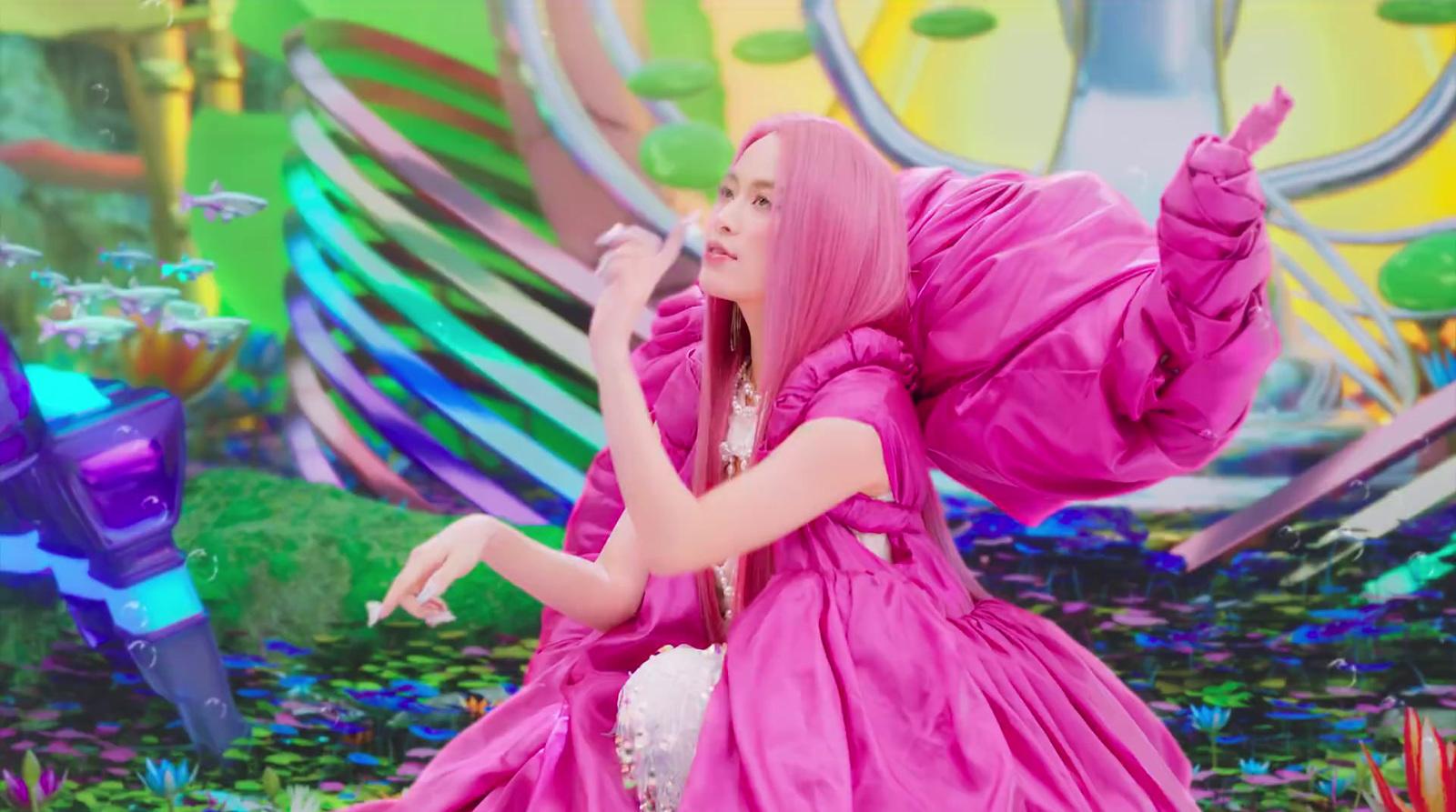 a woman in a pink dress standing on a stage