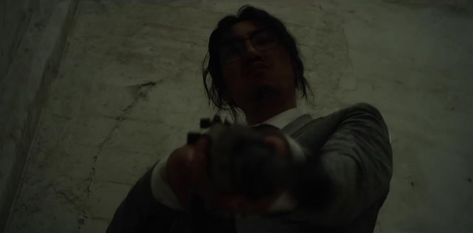a man holding a gun in his right hand