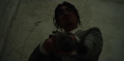 a man holding a gun in his right hand