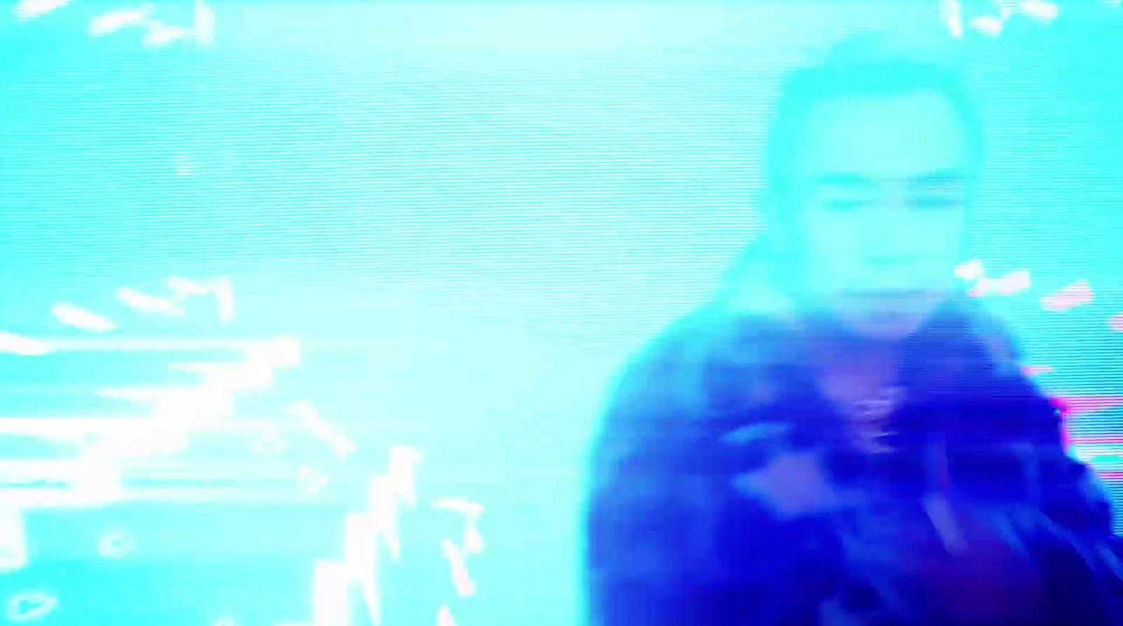 a man standing in front of a tv screen