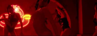 a woman standing in front of a mirror with a red light