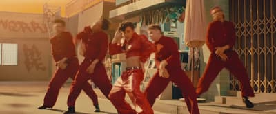 a group of young men in red outfits