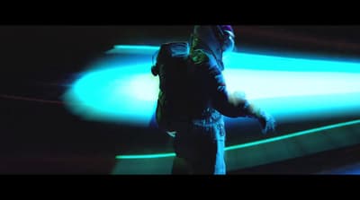 a man standing in front of a blue light