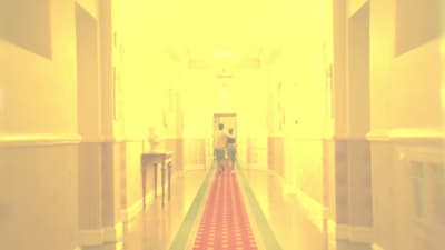 a long hallway with a red and green checkered floor