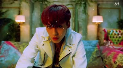a man with red hair sitting on a couch