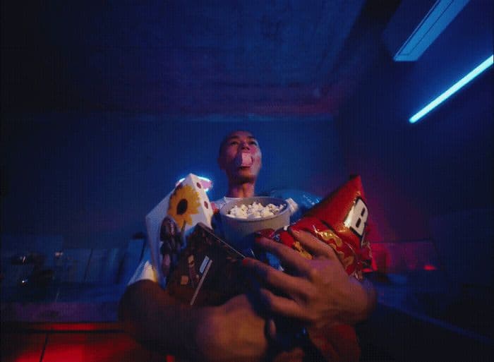 a man holding a bowl of popcorn and a bowl of popcorn