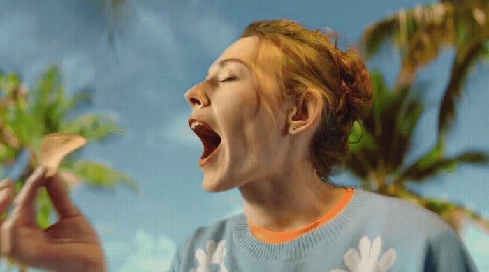 a woman holding a banana up to her mouth