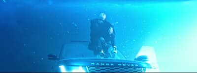 a man standing on top of a truck under water
