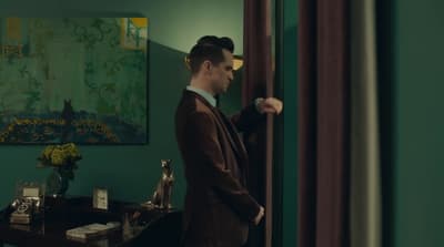 a man in a suit standing in a room