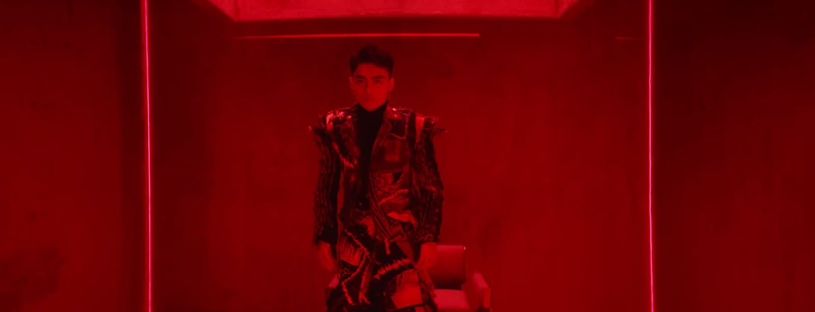 a man standing in a room with a red light