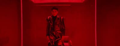 a man standing in a room with a red light