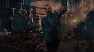 a man in a blue jacket pointing at something