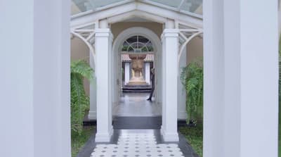 a white and black tiled walkway leading to a building