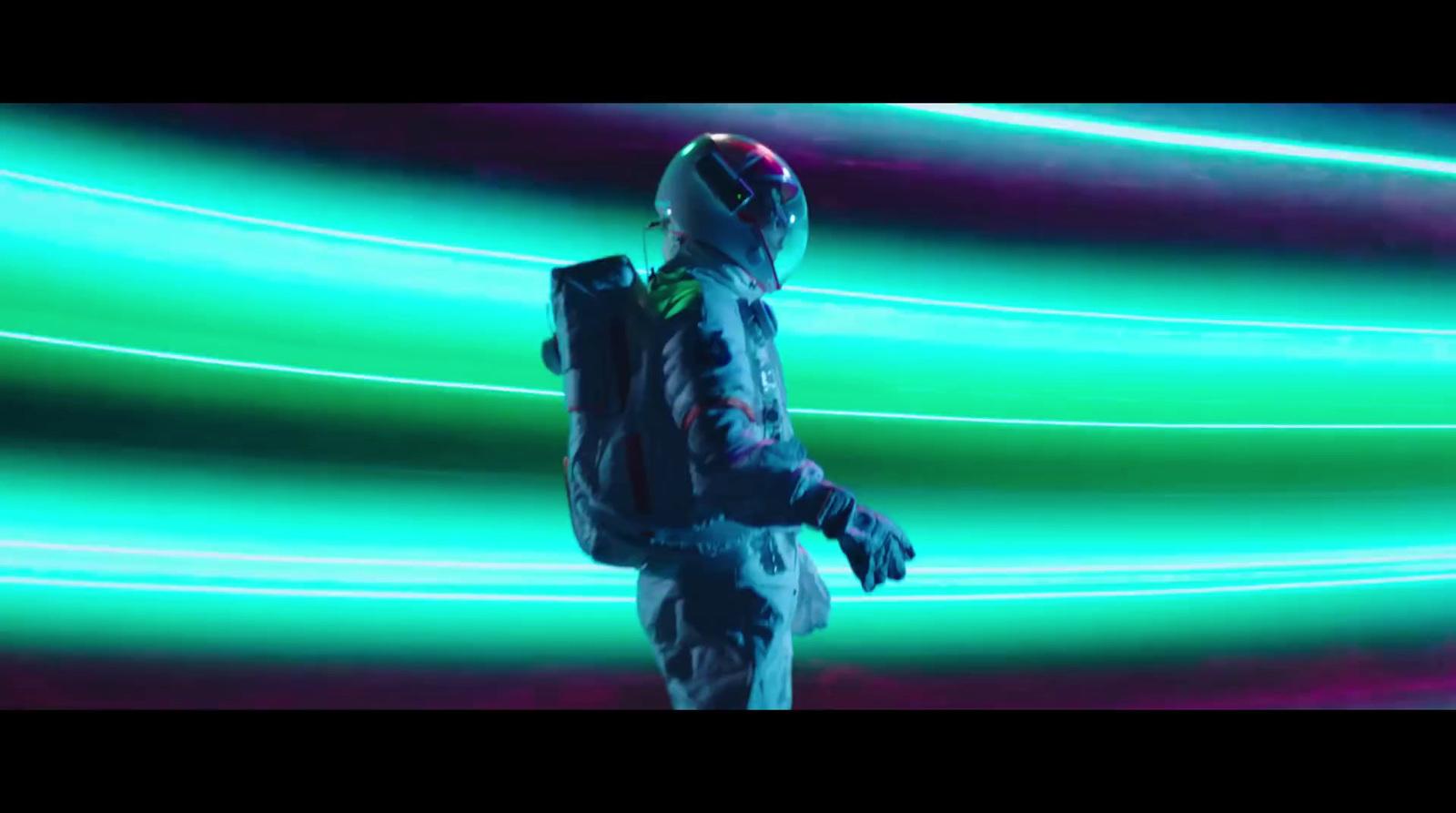 a man standing in front of a green light