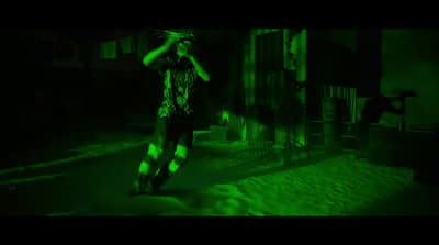 a man riding a skateboard down a street at night