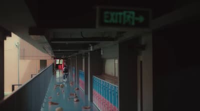 a long hallway with a sign that says exit