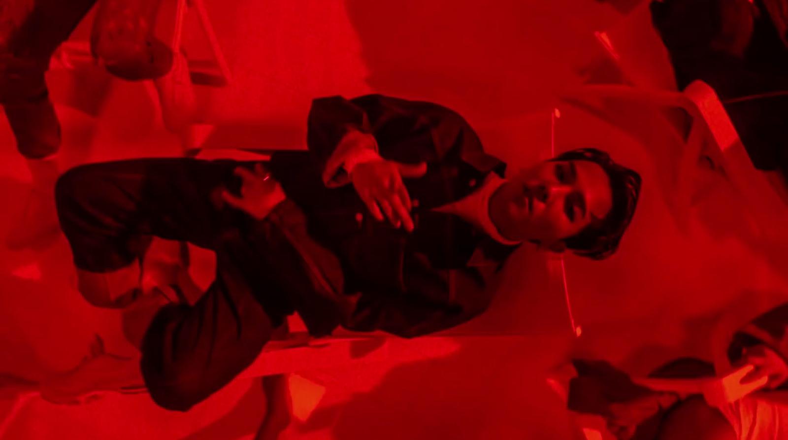a man standing in a room with a red light