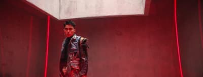a man standing in a room with a red light