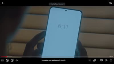 a person holding a cell phone with the number 611 on it
