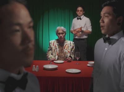 a group of men standing around a table with plates on it