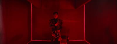a man standing in a room with red lights