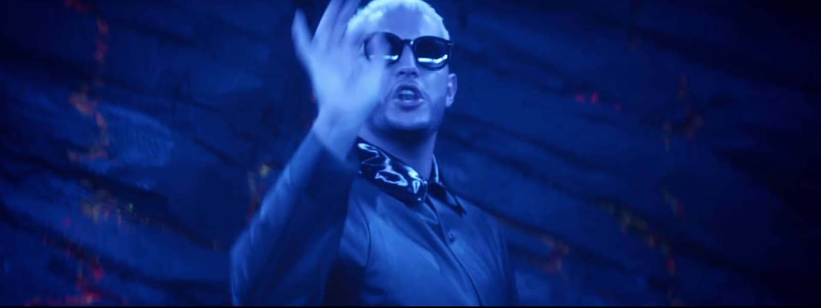 a man with sunglasses and a tie on
