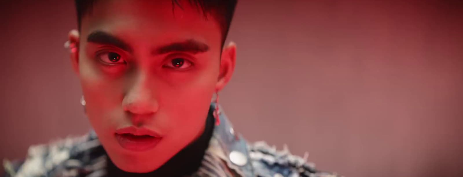 a close up of a person with red eyes