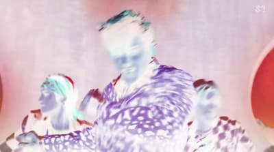 a blurry image of a man and a woman dancing