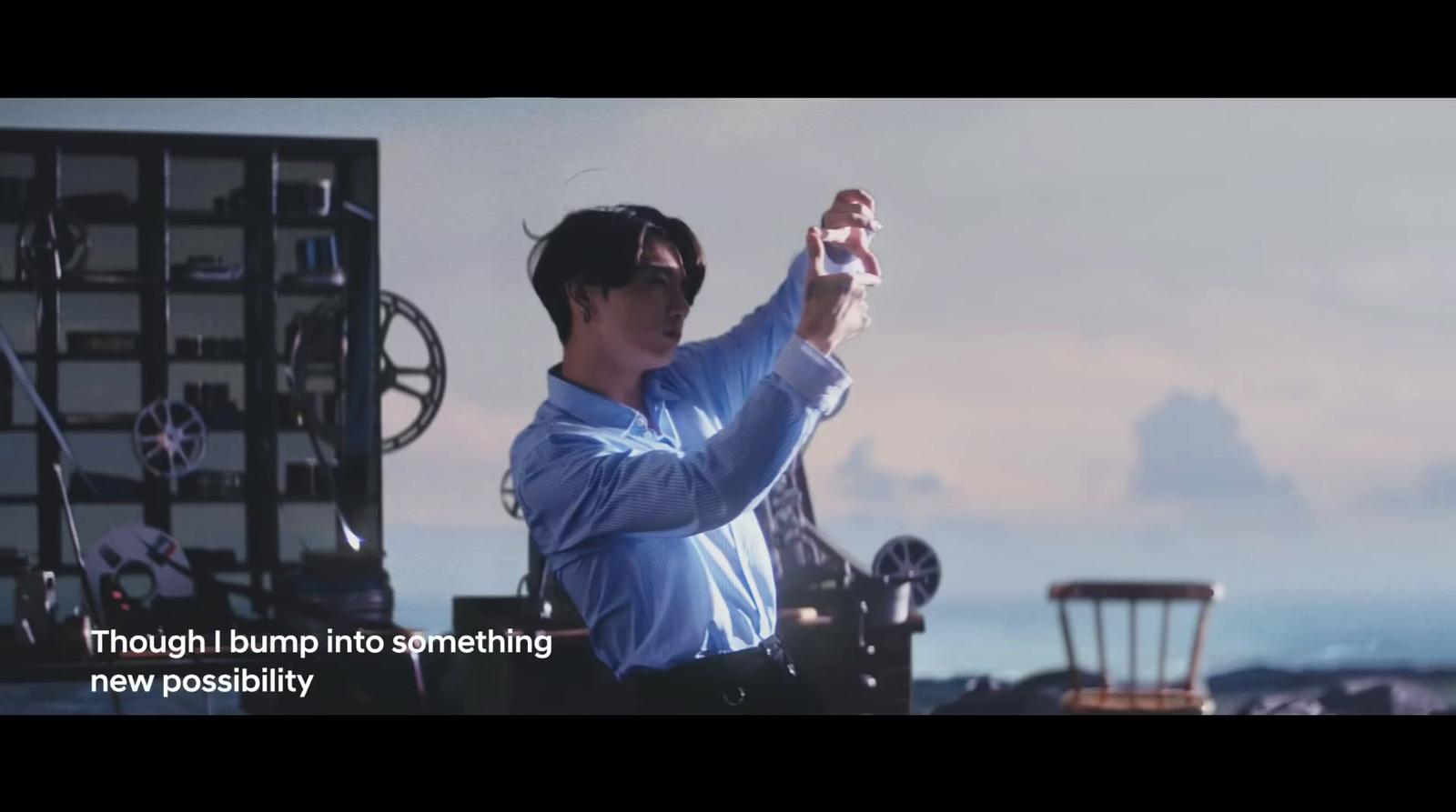 a man in a blue shirt is holding a toy