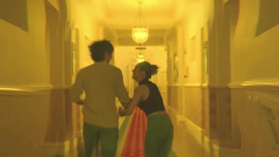 a man and a woman walking down a hallway
