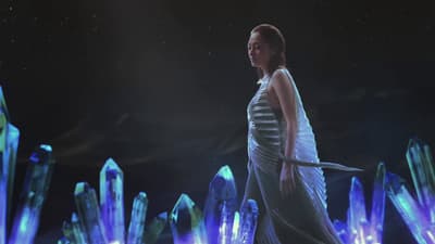 a woman in a white dress holding a sword