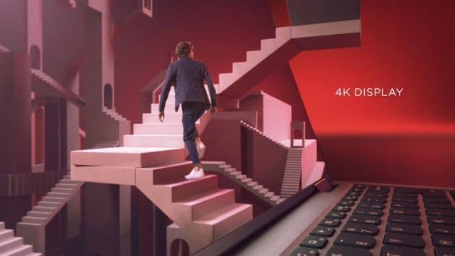 a man walking up a set of stairs next to a laptop