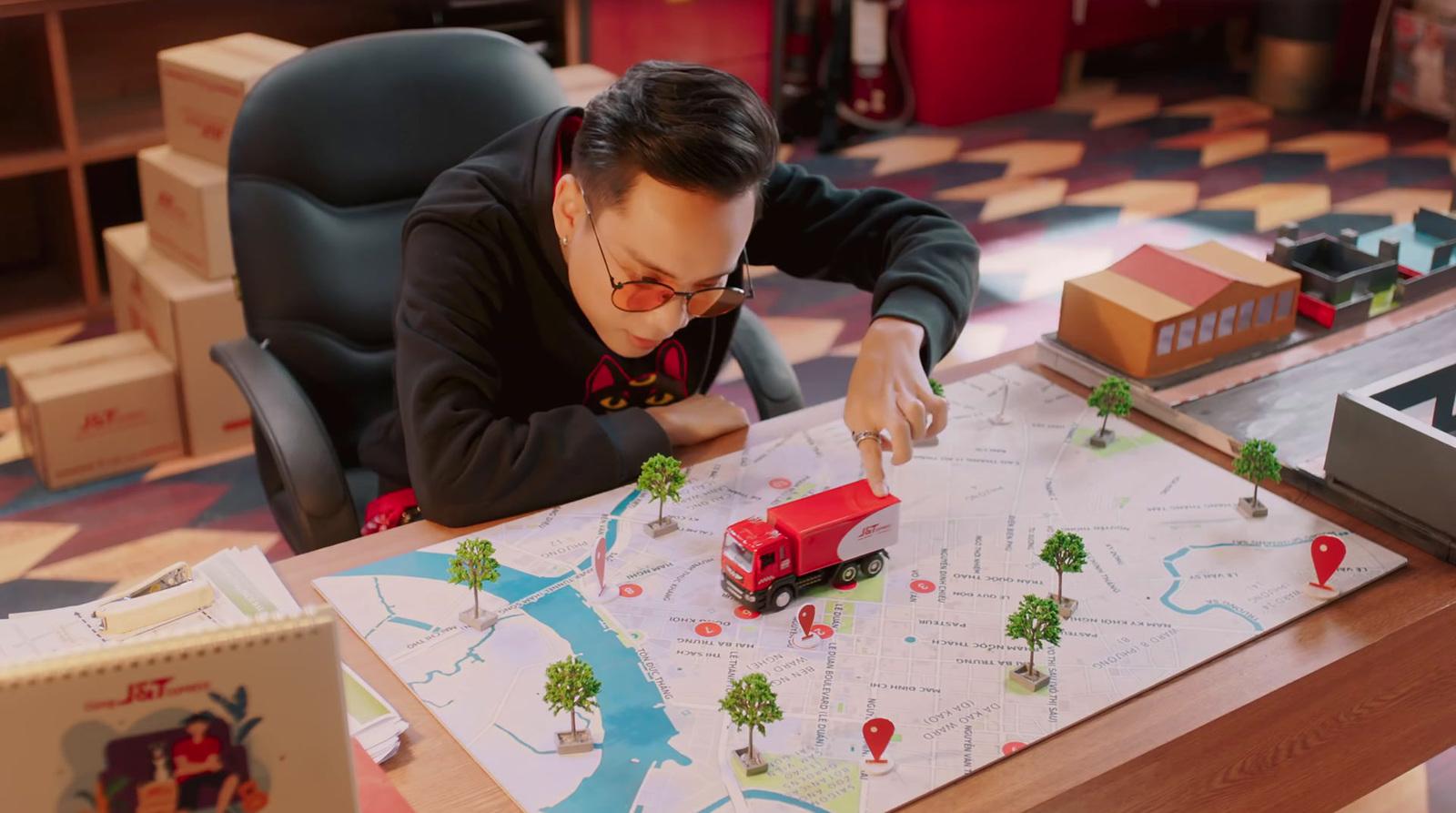 a man sitting at a table looking at a map