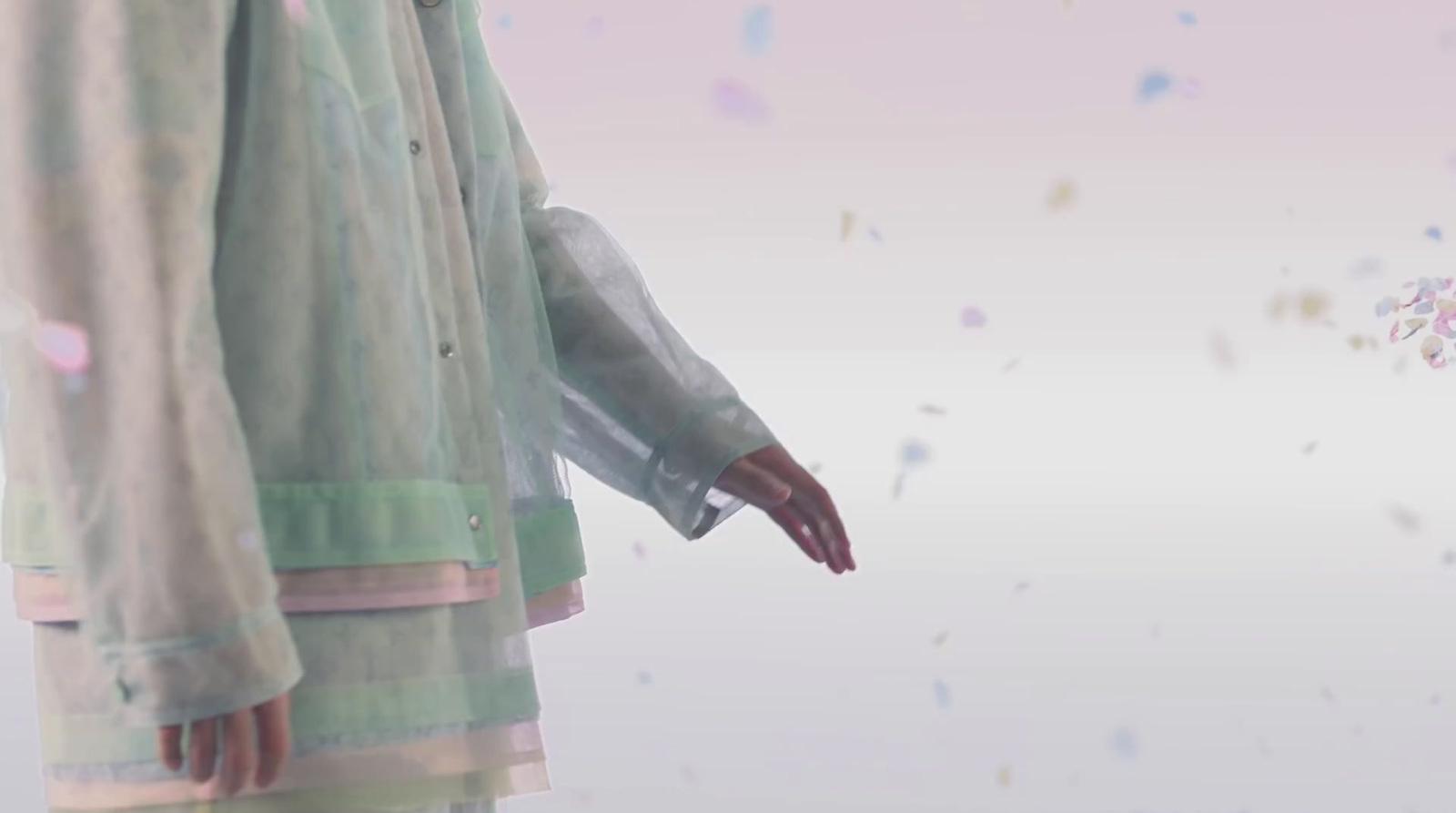 a person standing in front of a wall with confetti on it