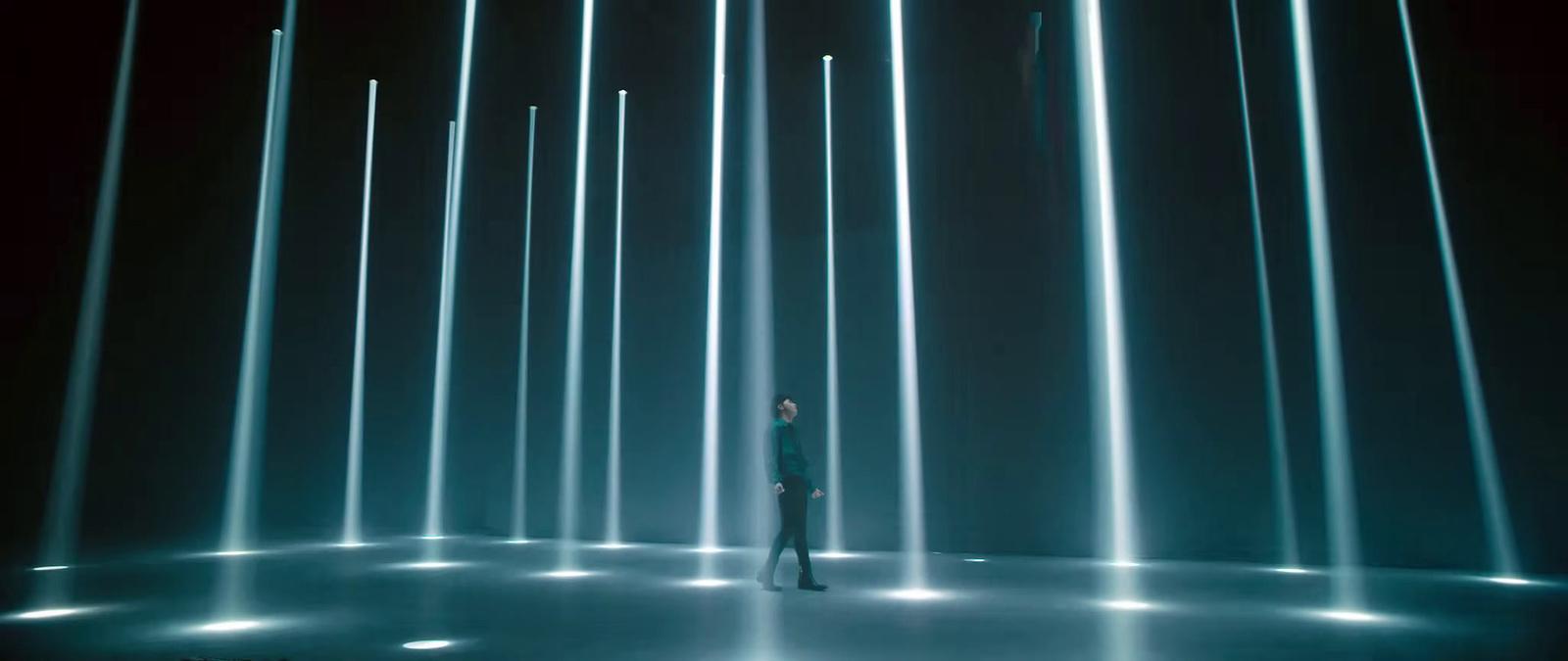 a person standing in front of a wall of lights