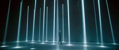 a person standing in front of a wall of lights
