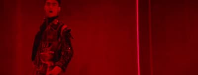 a man standing in front of a red light