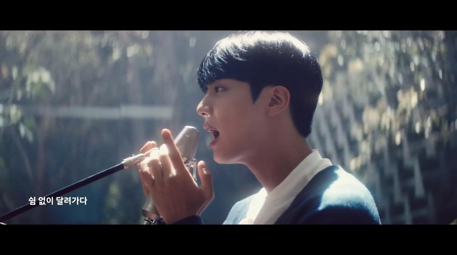 a young man singing into a microphone
