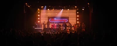 a group of people standing on top of a stage