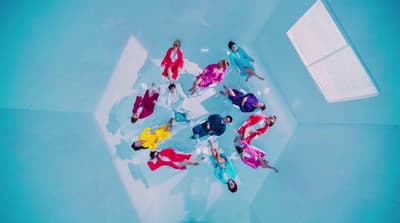 a group of people standing around in a pool