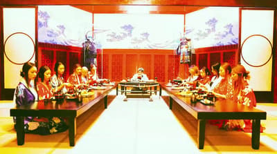 a group of women sitting at a long table